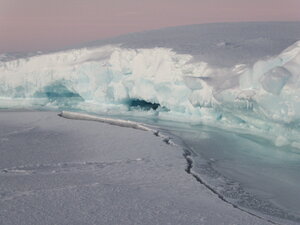 The stress breaking the sea ice where the ice floe meets the frozen surface.