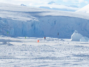 The station leader ready to guide the plane into its parking spot. And the iceberg currently resident at the end of the runway.